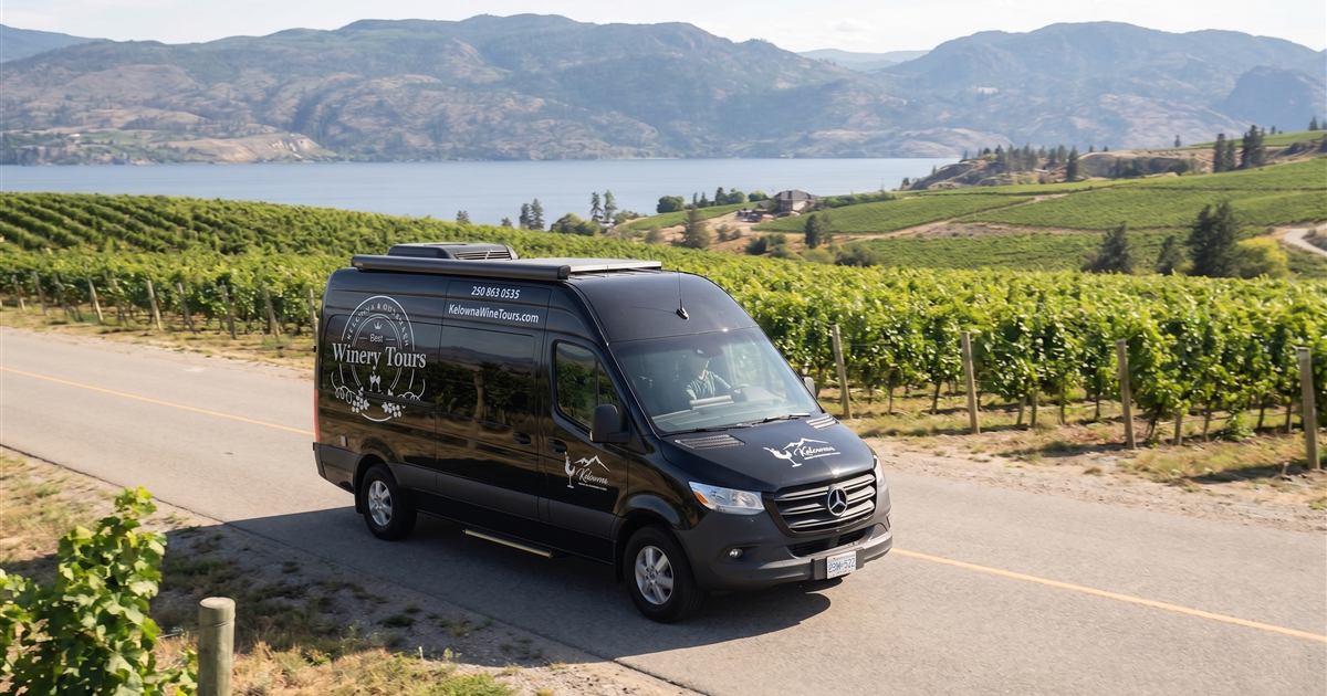 Kelowna Wine Tours van travelling through Okanagan wine country for local pickup